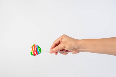 Sweets, lollipops in hand, on white background