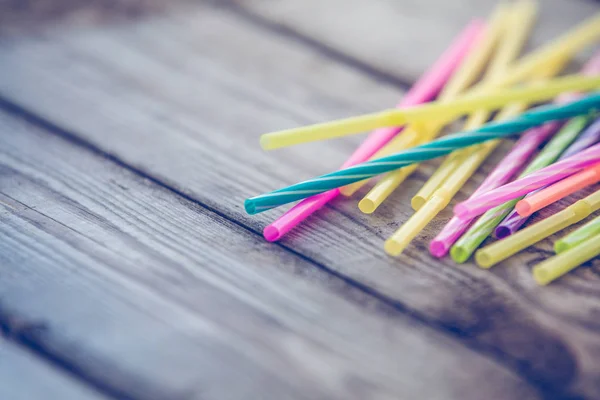 Plastic straws on wooden background plastic free concept