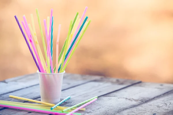 Plastic straws on wooden background plastic free concept