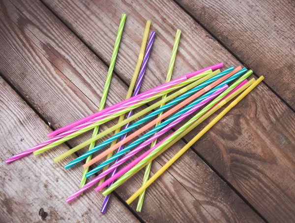 Plastic straws on wooden background plastic free concept