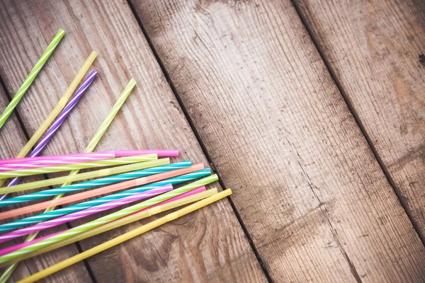 Plastic straws on wooden background plastic free concept