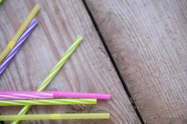 Plastic straws on wooden background plastic free concept