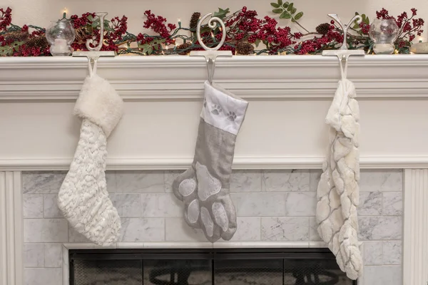 Three Christmas Stockings on a Fireplace Mantel