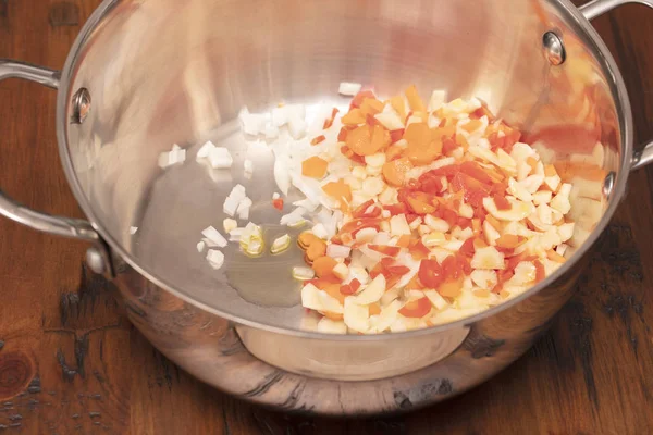 Zanahorias picadas y cortadas en cubitos, cebollas, ajo y aceite para un salteado —  Fotos de Stock