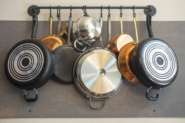 Kitchen wall rack for hanging pots, pans, aprons, and other uten