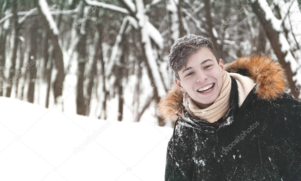 happy young man in the park in winter