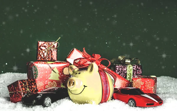 yellow pig with a red bow, miniature cars in the snow, presents