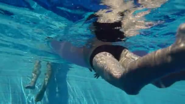 Barnet simmar i poolen med en uppblåsbar cirkel, Slowmotion — Stockvideo