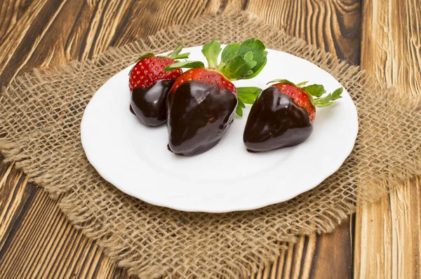 berry ripe strawberries in chocolate on a wooden background. Valentines Day.
