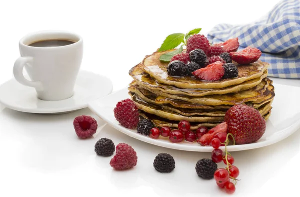 Delicious pancakes with berries and maple syrup on a white background — Stock Photo, Image