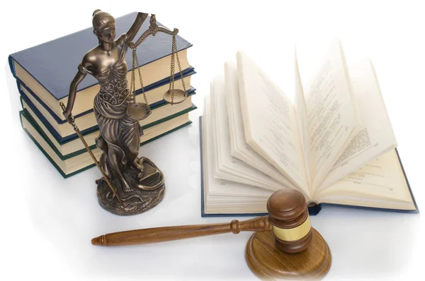 Ahşap masa arka planı açık bir kitap adalet heykeli. — Stok fotoğraf