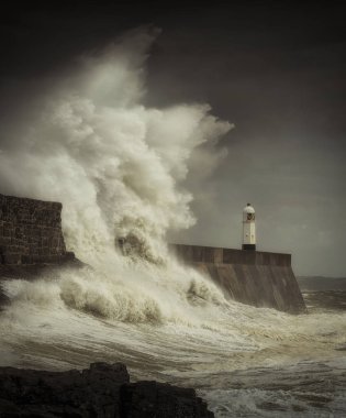 Dev dalgalar Güney Galler, İngiltere kıyılarında bir fırtınanın çenesinde Porthcawlporthcawl deniz feneri ve iskele vurdu.