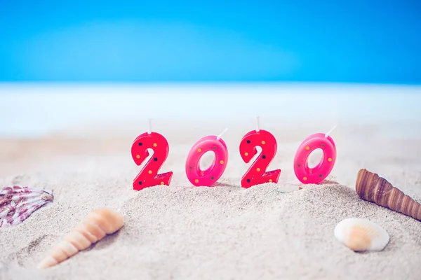 カラフルなキャンドルナンバー2 20お祝いの装飾コンセプト新年20のための画像 澄んだ青い空と青い海と砂のビーチの上 — ストック写真