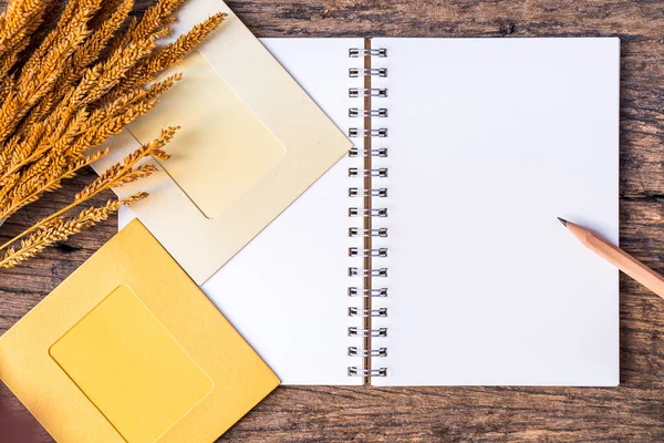 notebook with my best friend text on wooden floor with yellow grass flower and photo frame.vintage color tone.