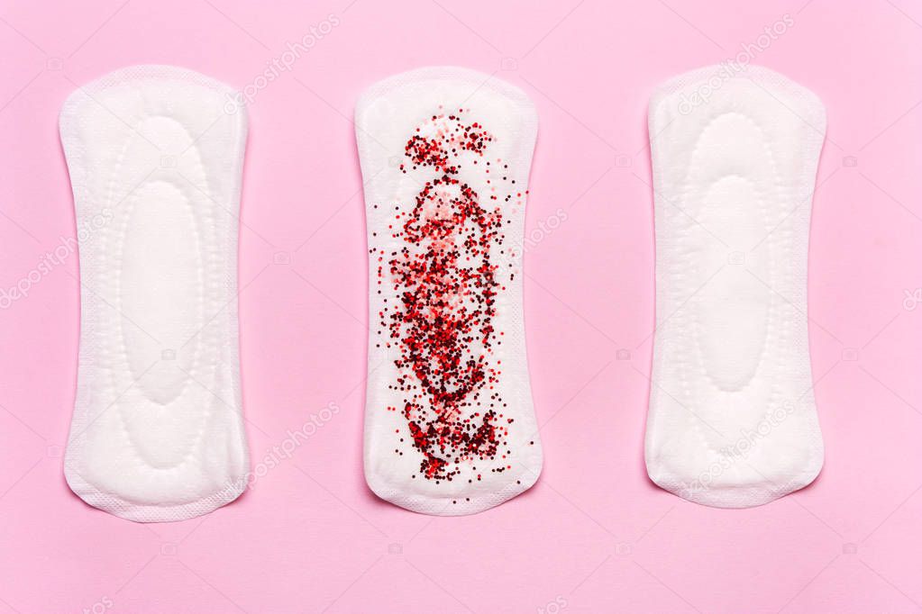 Women's hygiene products on a pink background. Concept of critical days, menstrual cycle, menstruation