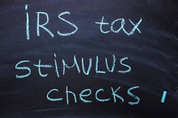 鉄税刺激チェックは黒板にチョークで書かれています ストックフォト