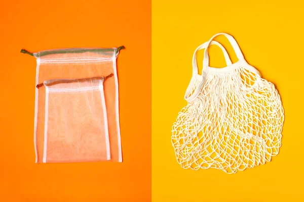 Set of reusable eco bags different sizes on a trendy orange background