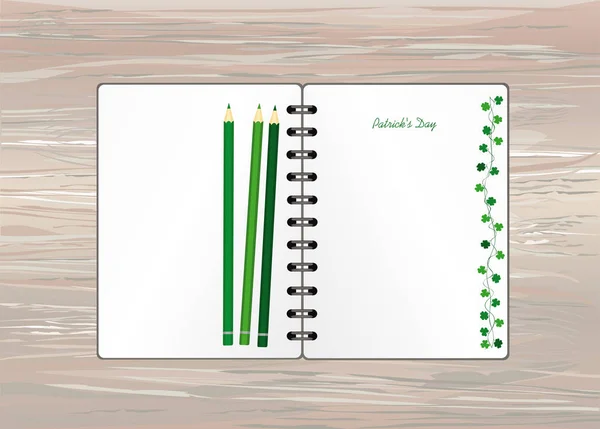 Notebook com modelo desenhado à mão Green festive bunting com trevo e lápis. Férias irlandesas - Feliz Dia de São Patrício com uma grinalda de três folhas. Cartão de felicitações nas férias. Vetor em backgro de madeira — Vetor de Stock