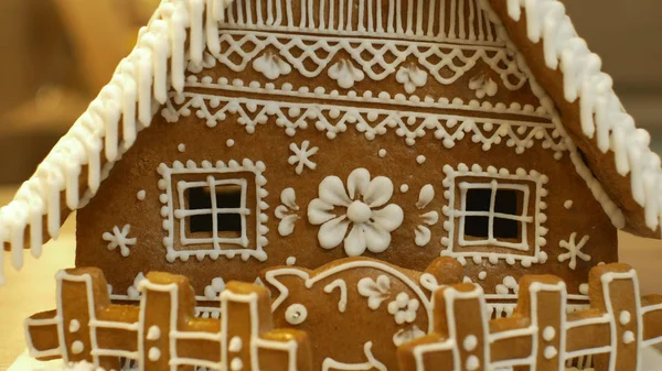 Gingerbread house and cottage cake beautiful, a fence with a piggy bank, decorated with a confectionery white icing with beaten egg whites, folk creative work, decoration for Christmas time