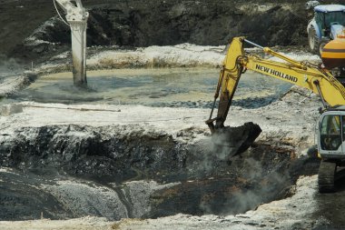 OSTRAVA, CZECH REPUBLIC, AUGUST 28, 2018: Liquidation of remediation of waste of oil toxic, poisoned pollutants, excavator and chemical reaction pollution clipart