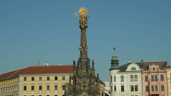 UNESCO heritage plague column holy trinity, people walk around the square Horni namesti, cultural national architectural monument and landmark, baroque sculptural group, column Stock Image