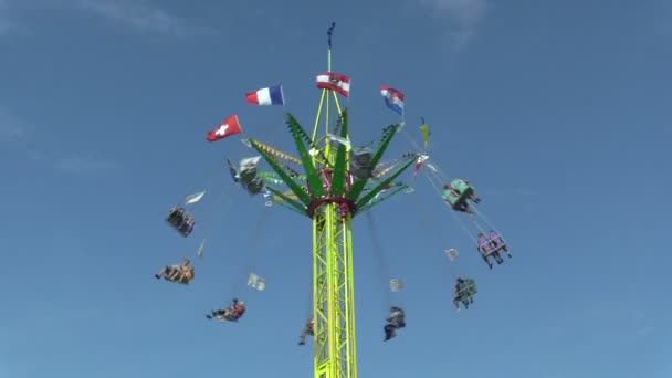 Roundabout chain, fun attraction, fairground with blue sky, carousel roundabout, swings amusement park, chain and iron steel structure with Czech, unrecognizable people enjoying ride, Europe — Stock Video