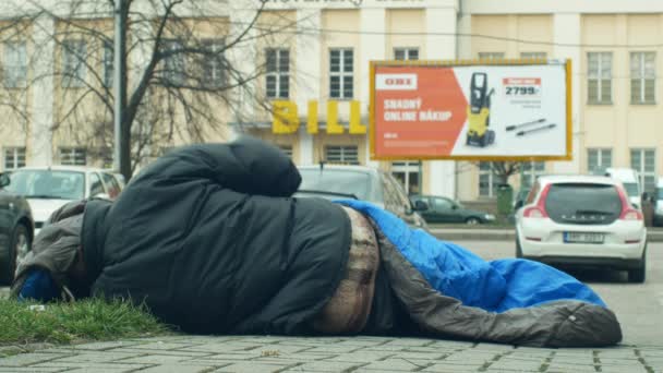 Olomouc, Tsjechië, 2 januari 2019: dakloos in slaap en slaap in slaapzak op straat authentieke emotie in de buurt van warenhuis winkelcentrum winkel, walking people Life City — Stockvideo