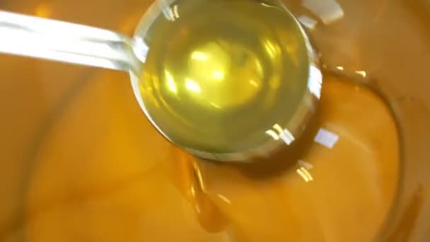 Sunflower oil organic quality bio, mixing and pouring in a steel barrel, for cold food and fried foodstuff, healthy cooking, gold seeds, vegetarian cuisine, filling bowl, bubbles active — Stock Video