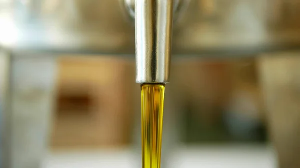 Rapeseed canola oil organic quality bio, pour and pouring in a steel barrel, for cold food and fried foodstuff, filling a bowl, aromatic bubble rape-oil colza, vegetarian cuisine