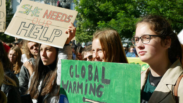 BRNO, CZECH REPUBLIC, SEPTEMBER 20, 2019: Friday for future, demonstration against climate change, banner sign she needs our help. Global warming, crowd young people students ecology