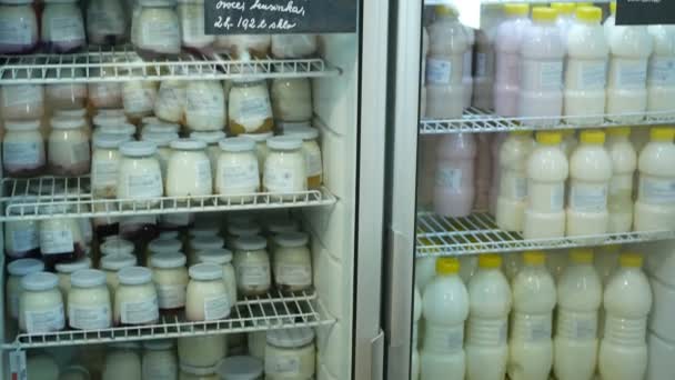 OLOMOUC, CZECH REPUBLIC, MAY 25, 2019: Cooling cabinet box organic bio quality dairy farm shop foodstuffs goods, glass door grocery store and milk, yogurt, sour milk, dairy products cool — Stock Video