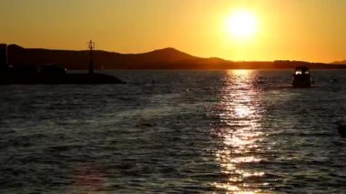 Hırvatistan 'ın Biograd kentinde gün batımında yat ve botlar marinaya girip çıkıyor