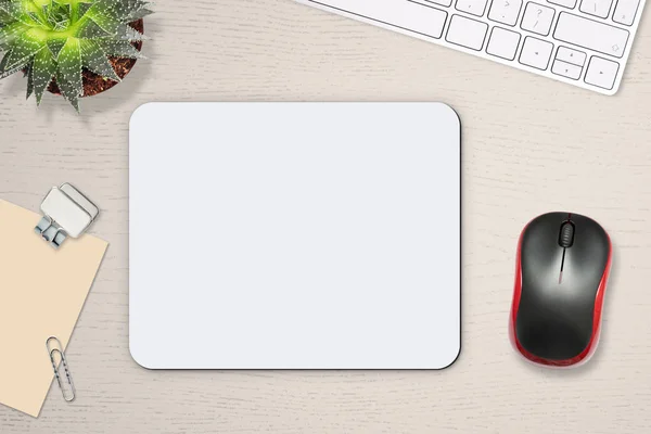 Mouse pad mockup. White mat on the table with props, mouse and keyboard.