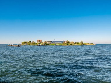 Man-made fort island Pampus with small harbour and restaurant in IJmeer lake near Amsterdam, Netherlands