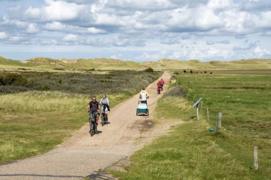 Amrum, Germany - Aug 26, 2023: Active people in nature reserve Amrumer Odde in north of Amrum island, North Frisia, Schleswig-Holstein clipart
