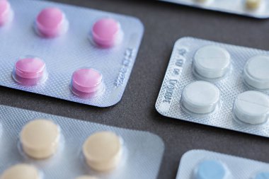 Tabletler ve hapları gri arka plan üzerinde çeşitli ilaç ambalajı