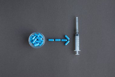 Mavi haplar ve gri arka plan üzerinde şırınga