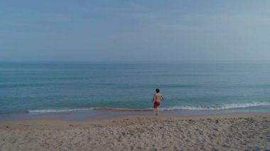 deniz suda çalışan kırmızı yüzme şortu giymiş adam 