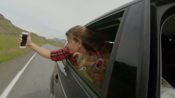 Young girl makes selfie out of car window — Stock Video