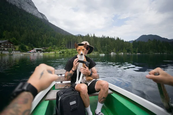 Traveller man with best friend dog on boat