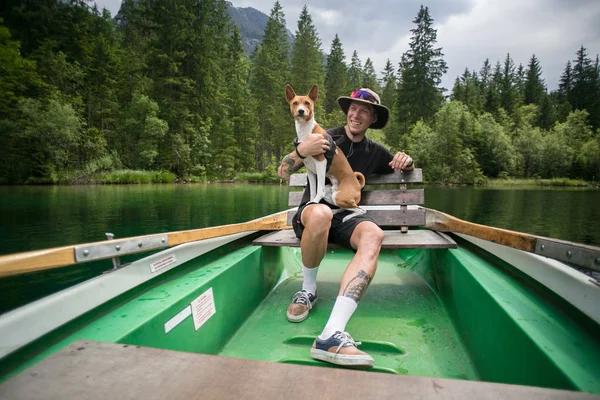 Traveller man with best friend dog on boat