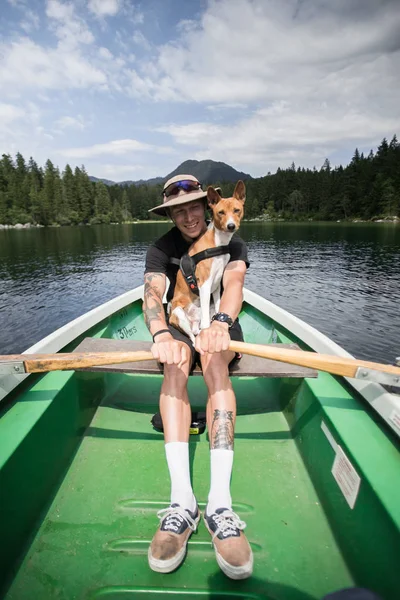 Traveller man with best friend dog on boat