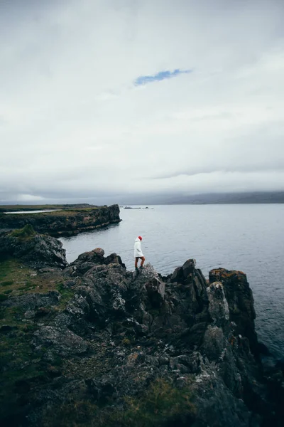 Fisherman or sailor stands on cliffs or rocks — Stock Photo, Image