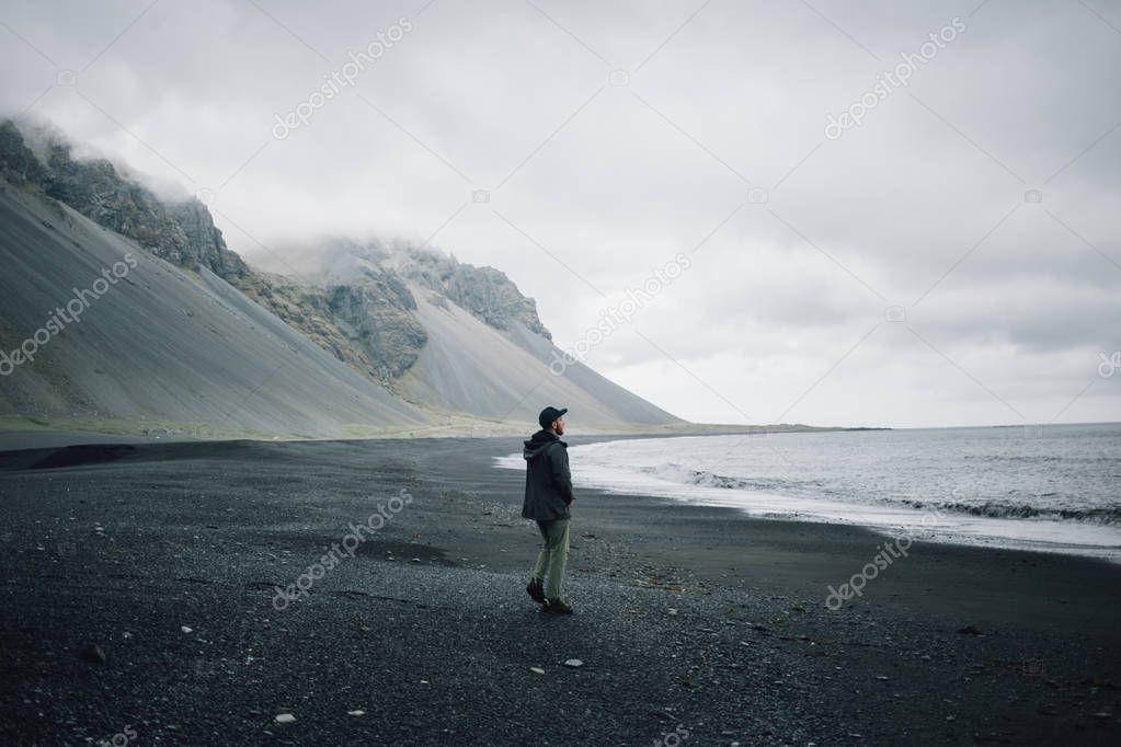 Lonely Man Walks On Grey Black Volcanic Sand Beach Lonely Man Walks On Grey Black Volcanic Sand Beach