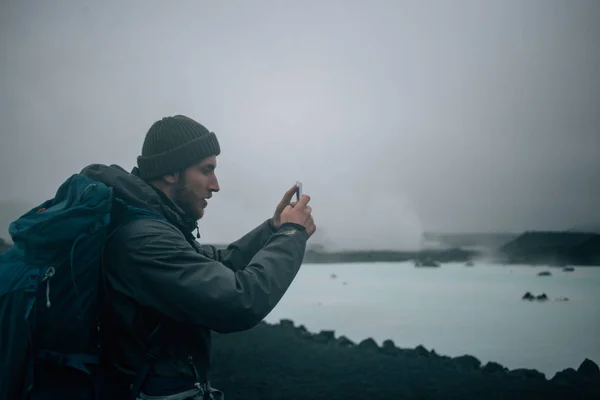 Handsome tourist with backpack in iceland scenery — Stock Photo, Image