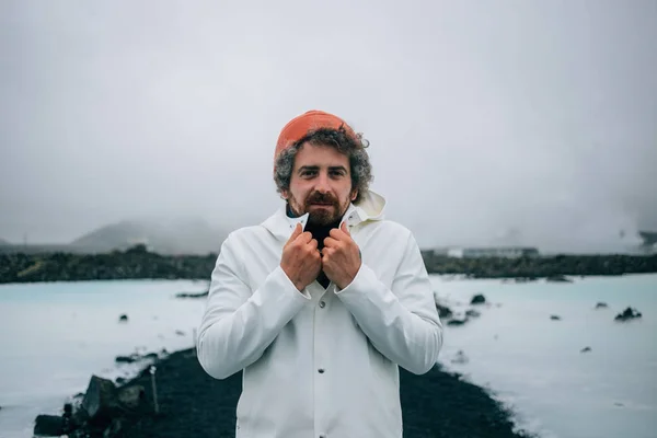 Adult handsome man shivers in cold iceland winter