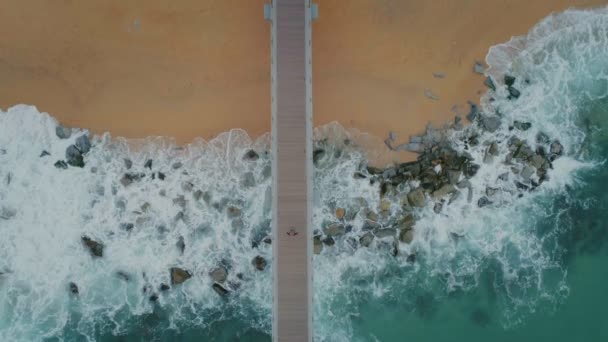 Top view from drone on pier on stormy beach — Stock Footage Top view from drone on pier on stormy beach Video Clip