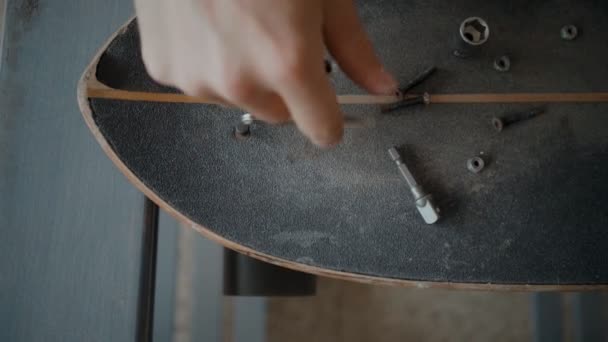 Skateboardåkare regrips styrelsen diy på verkstad — Stockvideo