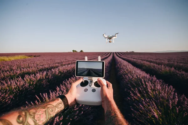 Hands hold drone remote control pov