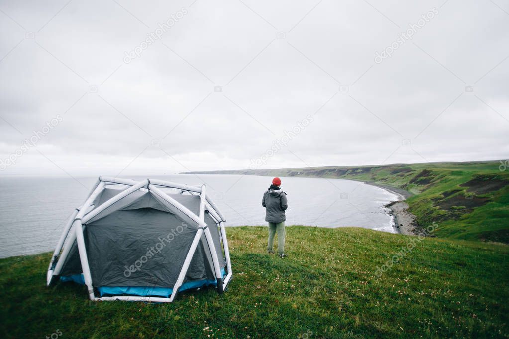 Futuristic inflatable tent on edge of epic cliff